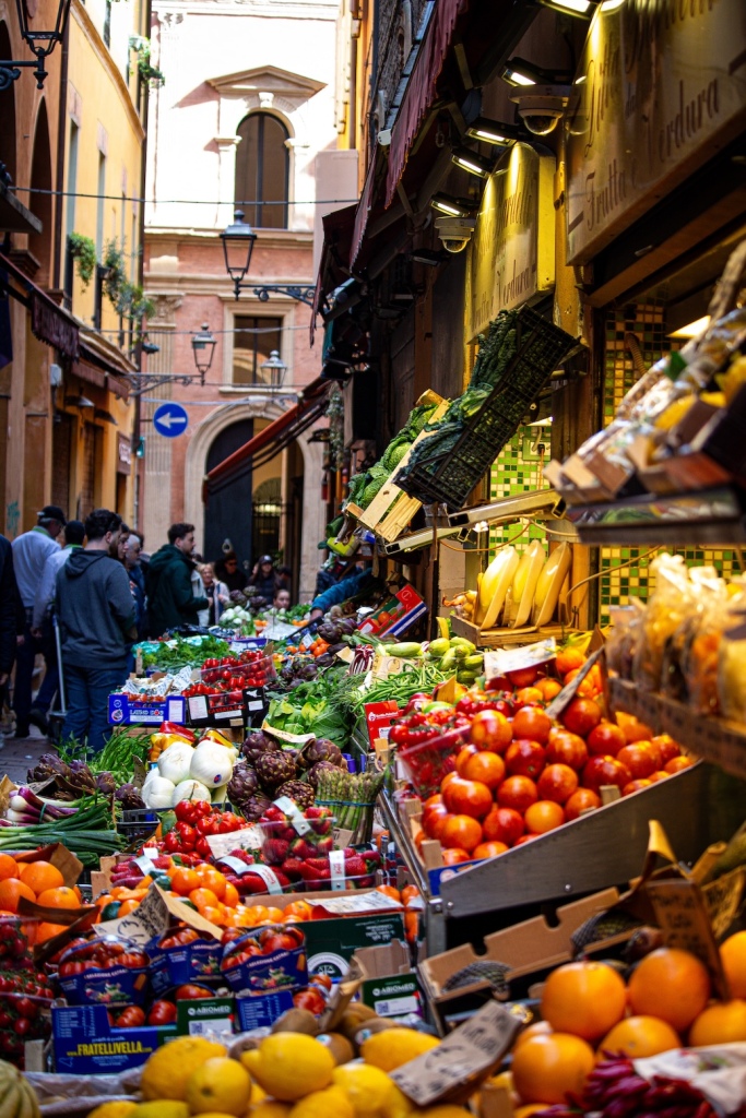 A fruit and vegatable stand in a narrow alley in Bologna, Italy March 2024