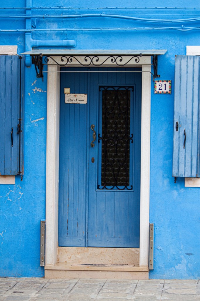 Blue front door and house in Burano, Italy, March 2024